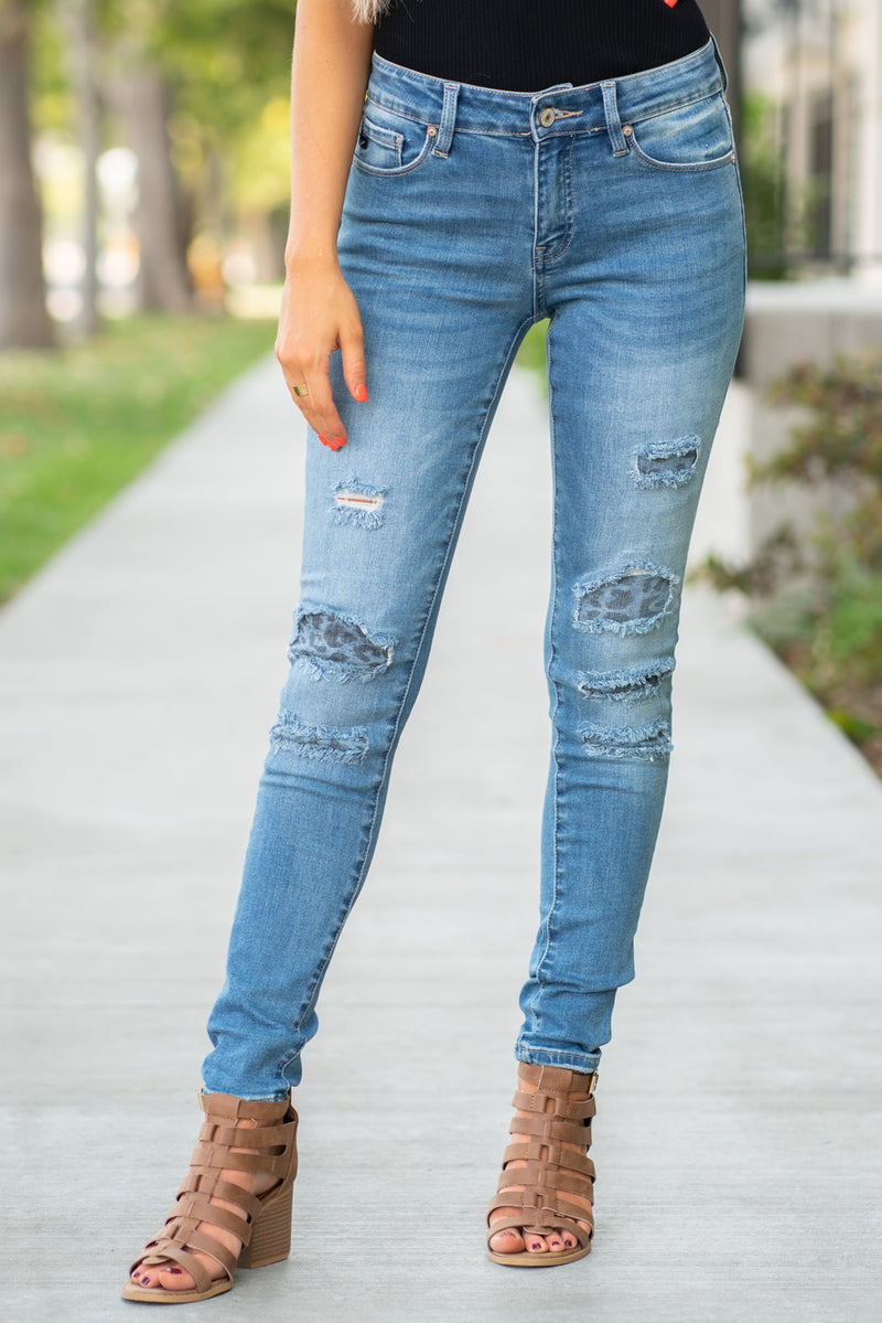 medium wash distressed skinny jeans with leopard print patch