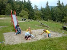 children playing in sandpit whilst camping
