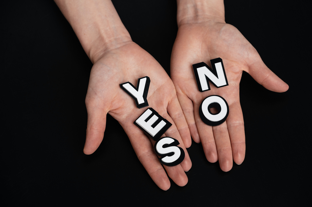Handing out a yes and no sign.