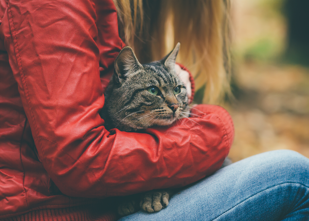 Girl cuddling her cat