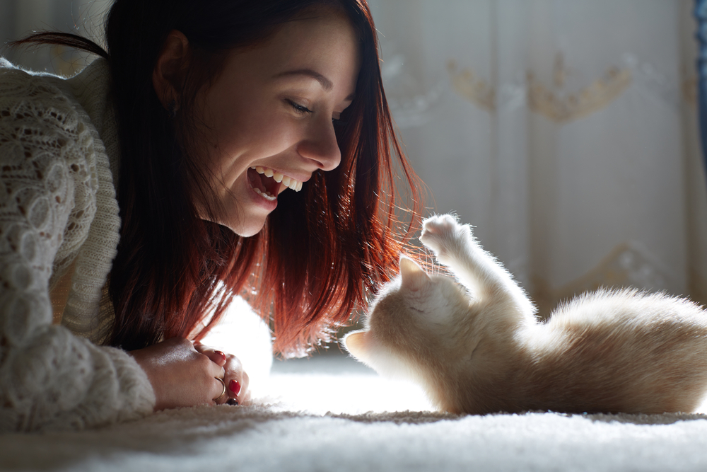 Woman playing with her cat