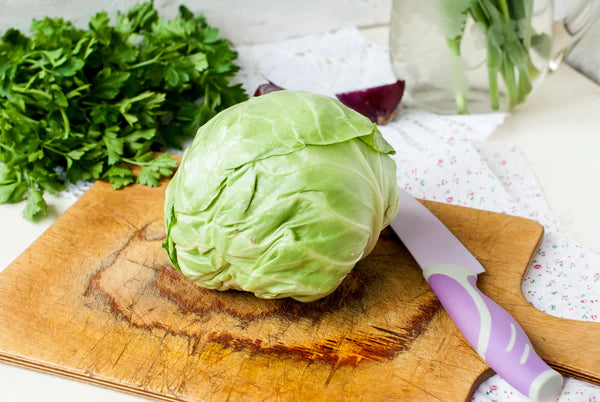 young cabbage on a cutting board and knife