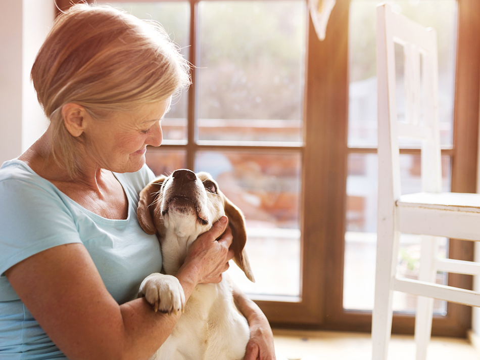 Woman cuddling her dog