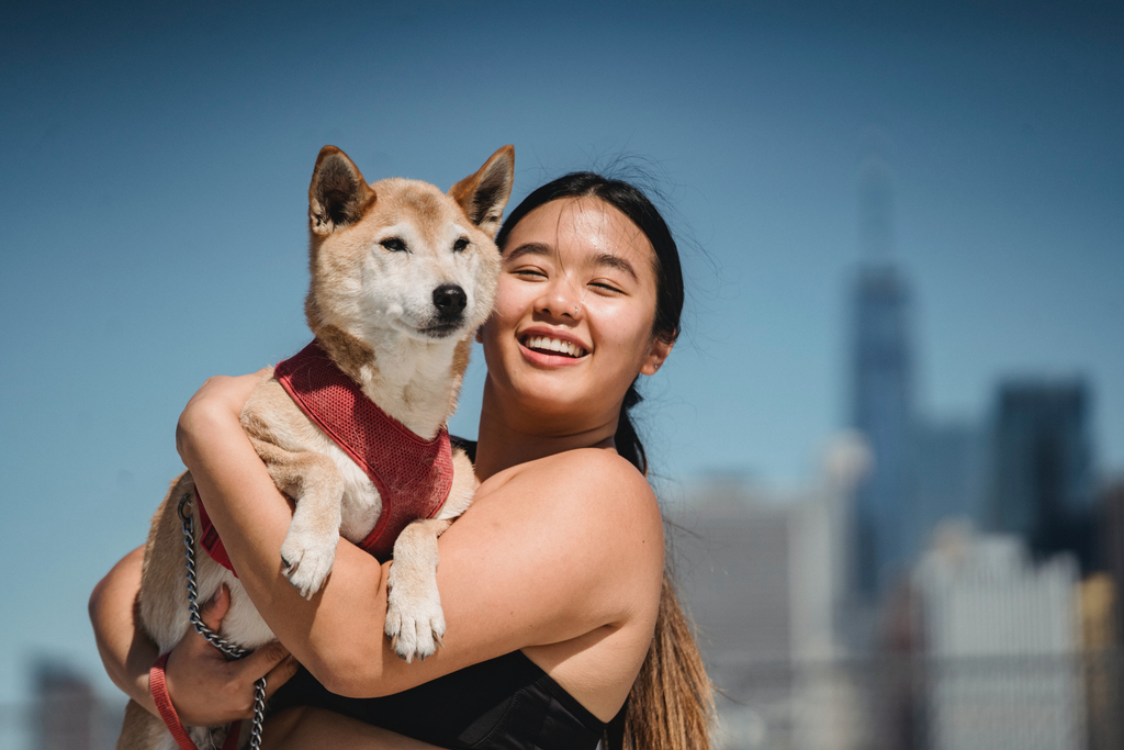 fur parent carrying her pet dog