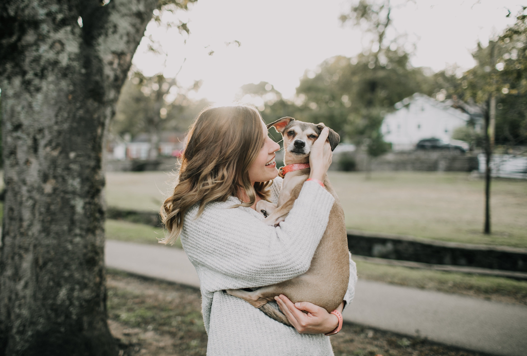 owner hugging her pet dog