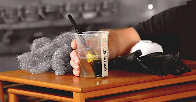 paint stripper, coarse wire wool and protective gloves used to strip a teak Nathan table