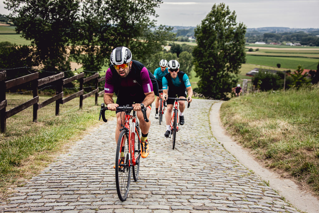 Belgian Crew boys club cycling on cobbles Flanders