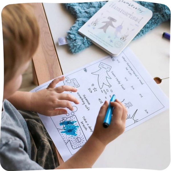 A child coloring a Hammerhead worksheet