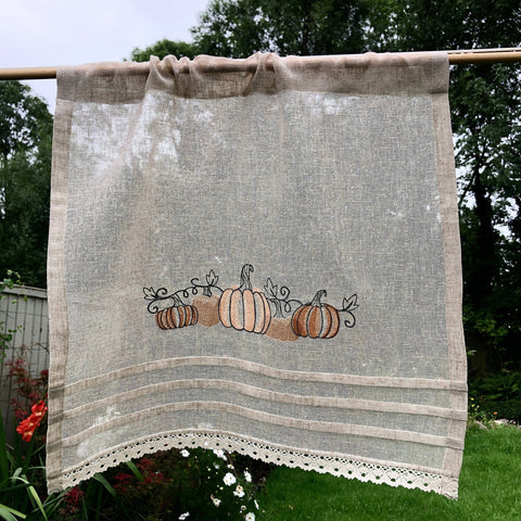 Natural linen Cafe Curtain embroidered with a line of cute autumn pumpkins.