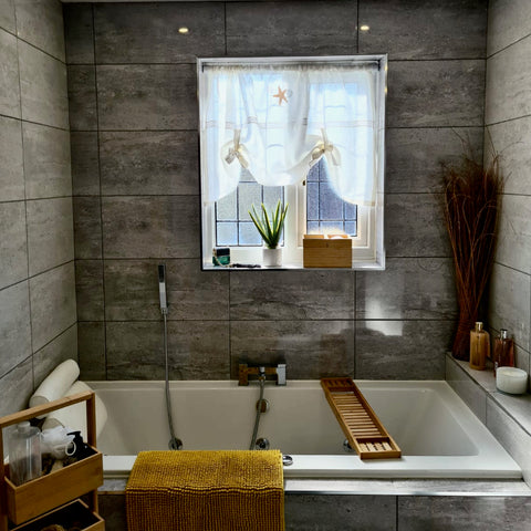 Photo of a Coastal inspired bathroom featuring a Linen & Letters linen curtains embroidered with a starfish.