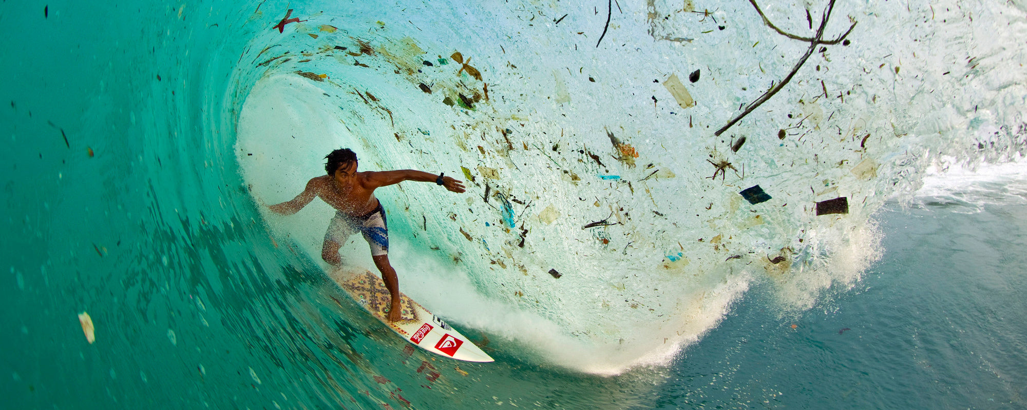 Surfer surrounded by plastic in Bali - Zak Noyle
