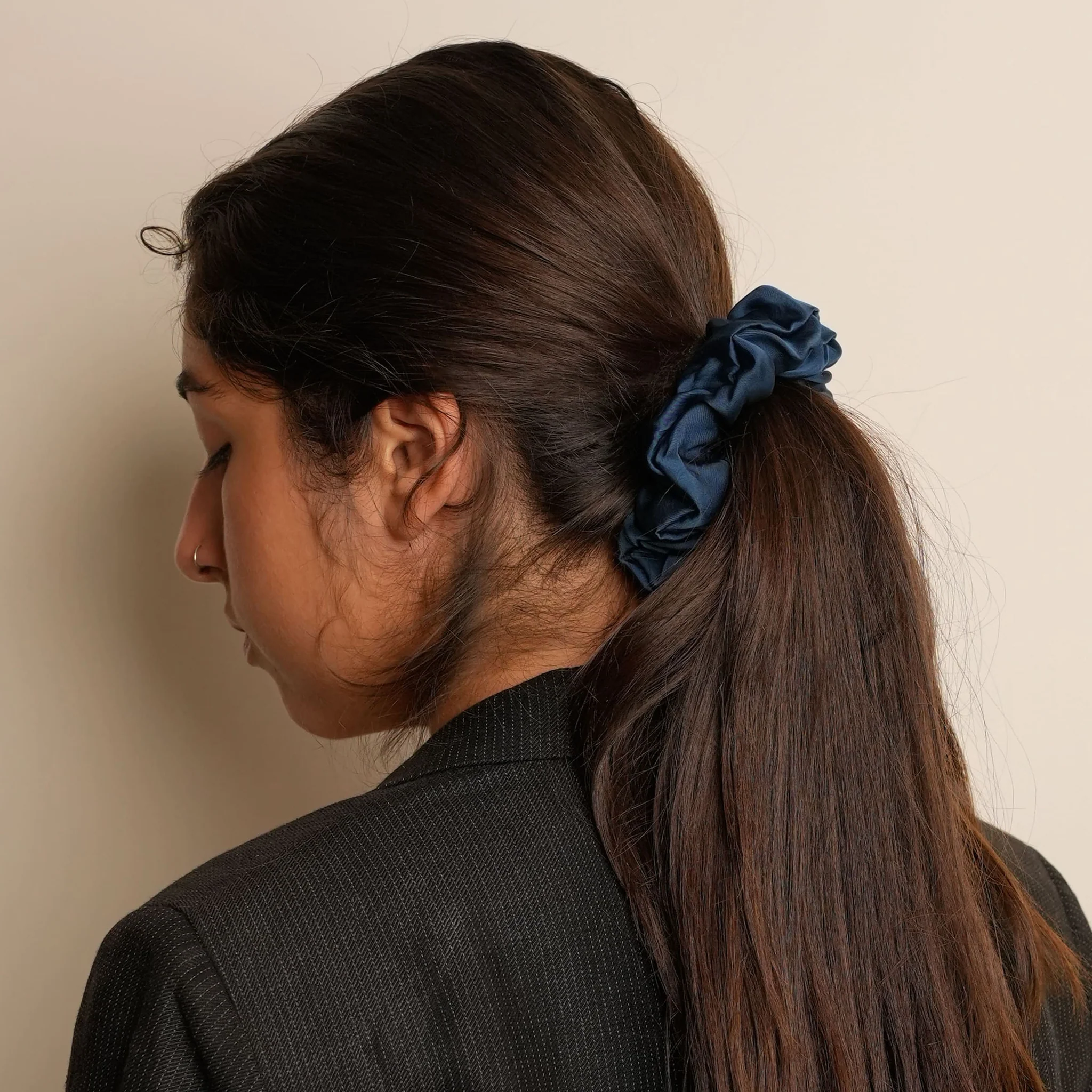 Model wearing aesthetically designed scrunchie are handcrafted in 100% mulberry silk.