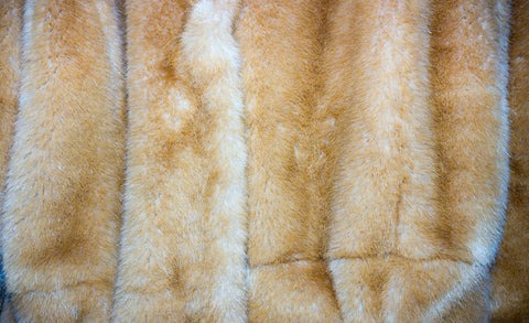 a close up of a fur coat with a tie on it