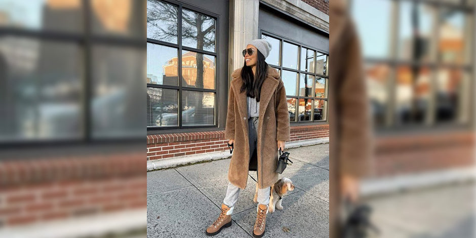 a woman walking down the street with a dog