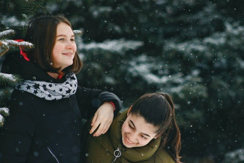 two girls enjoying snowfall