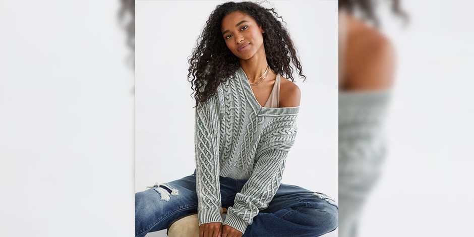 women sitting on the ground wearing grey knitted sweater