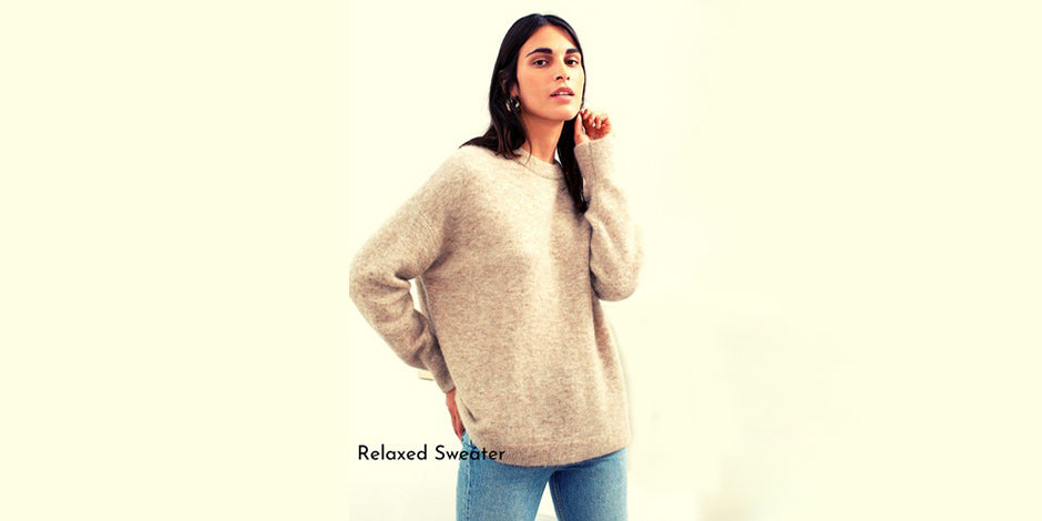 women wearing relaxed biege sweater with white background