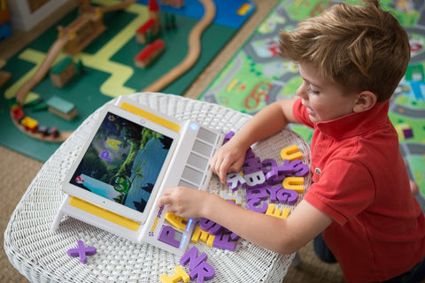 Little boy playing with Lagoon game on Square Panda playset