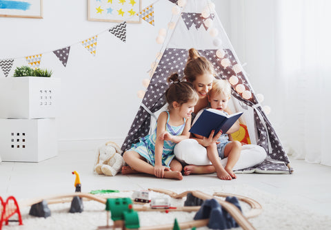 Mom reading books with her children to encourage a love of reading