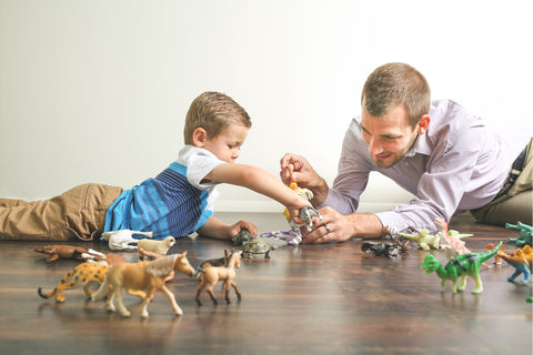 Dad playing toys with his son 