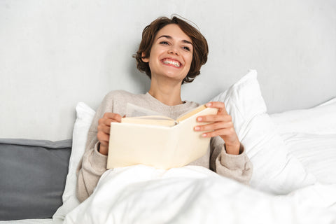 Woman happy and reading a book