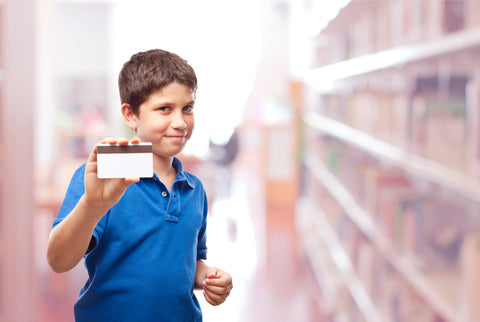 Boy holding a library card