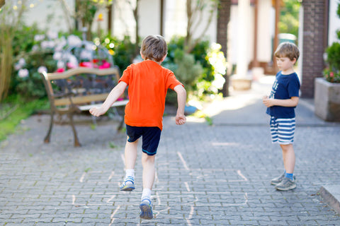 Kids playing letter hopscotch to learn their letters