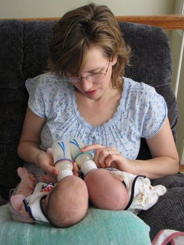 Mom bottle feeding twins