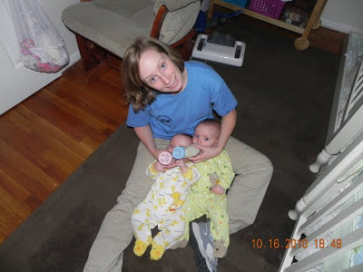 Mom bottle feeding twins