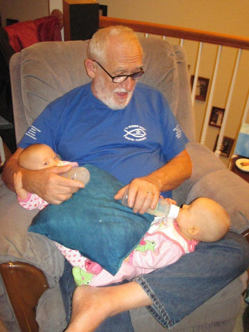 grandpa bottle feeding twins