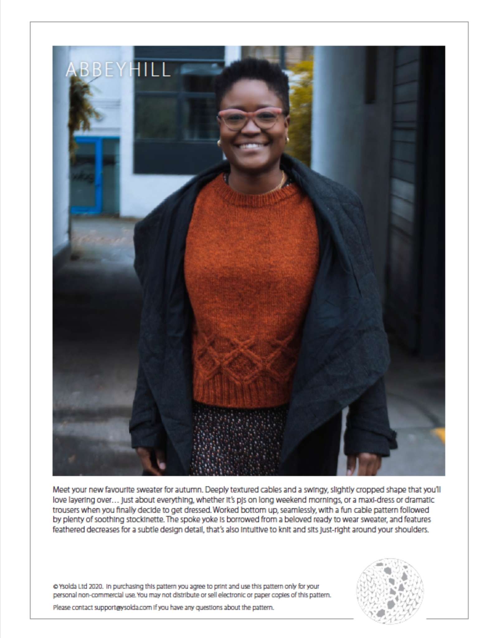 cover page of a pattern showing a black woman wearing an orange sweater, walking towards the camera. She wears a dark jacket that is open at the front and is smiling. Text describing the sweater design is shown underneath.