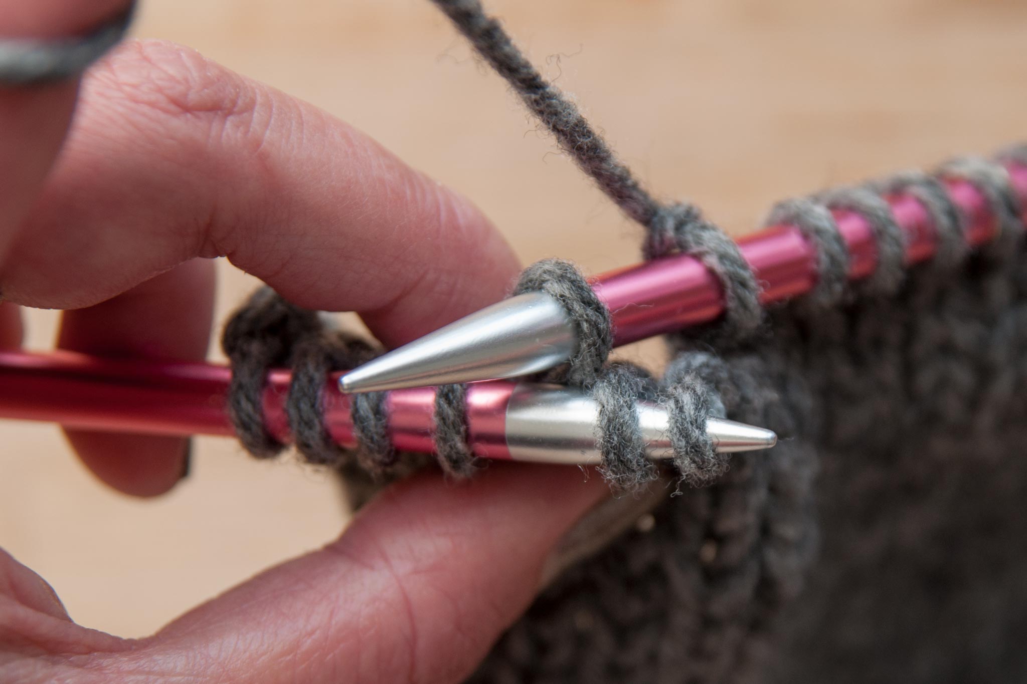 Pick up 2 loose stitches with the left needle at the front.