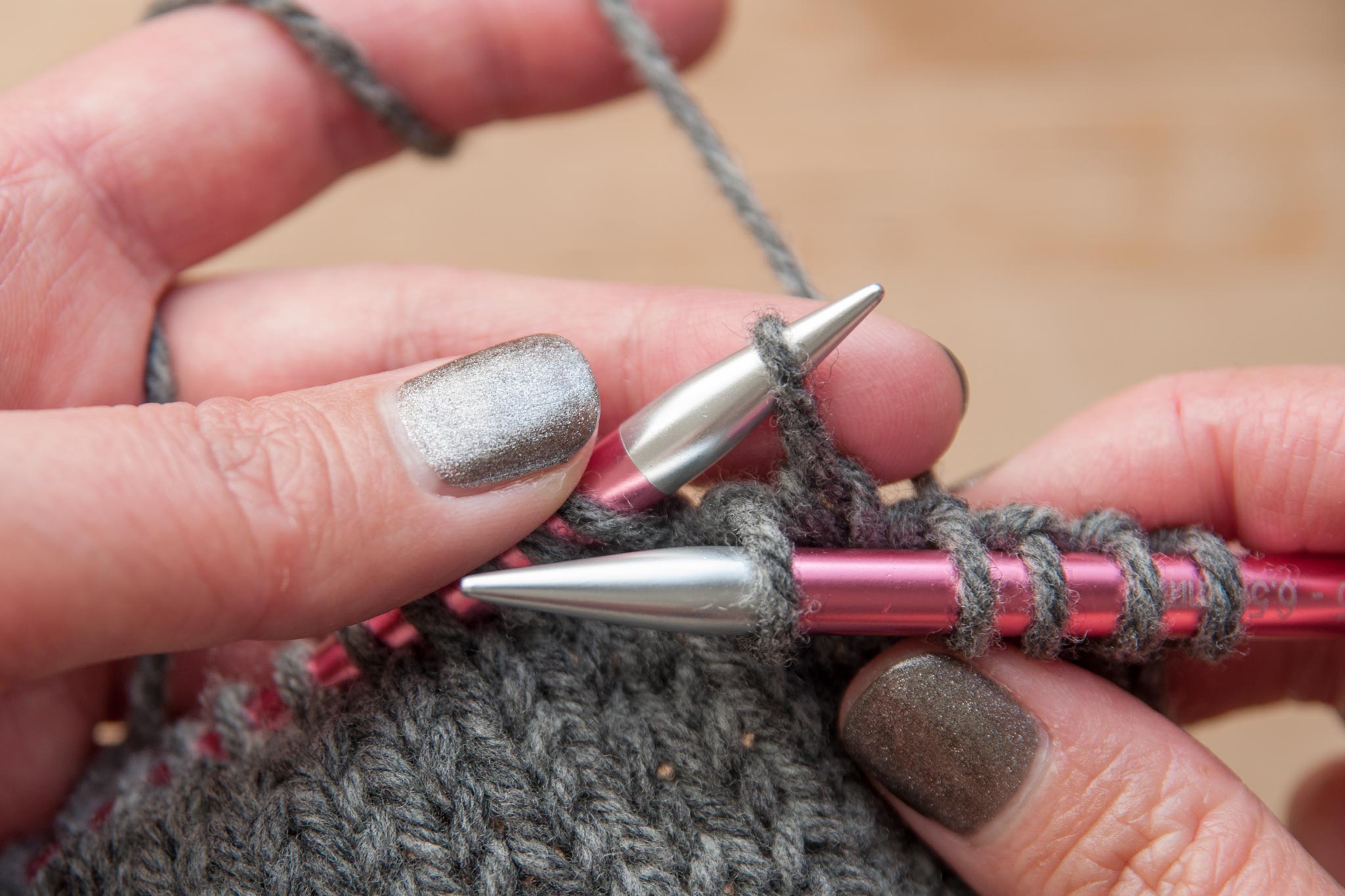 Pick up the loose stitch with the left needle.