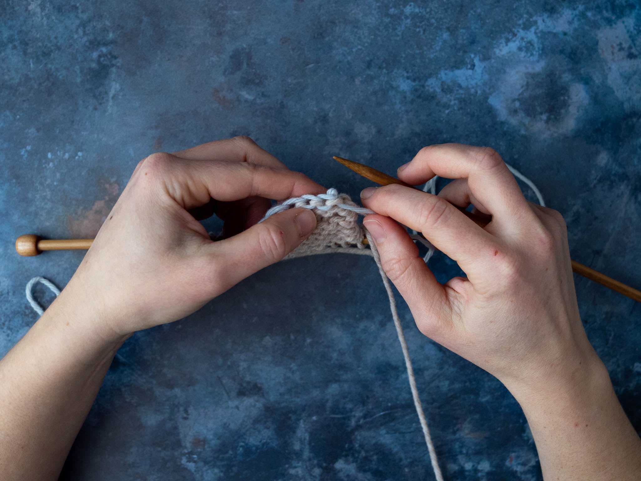 Place live stitches onto the needle as you unzip the chain.