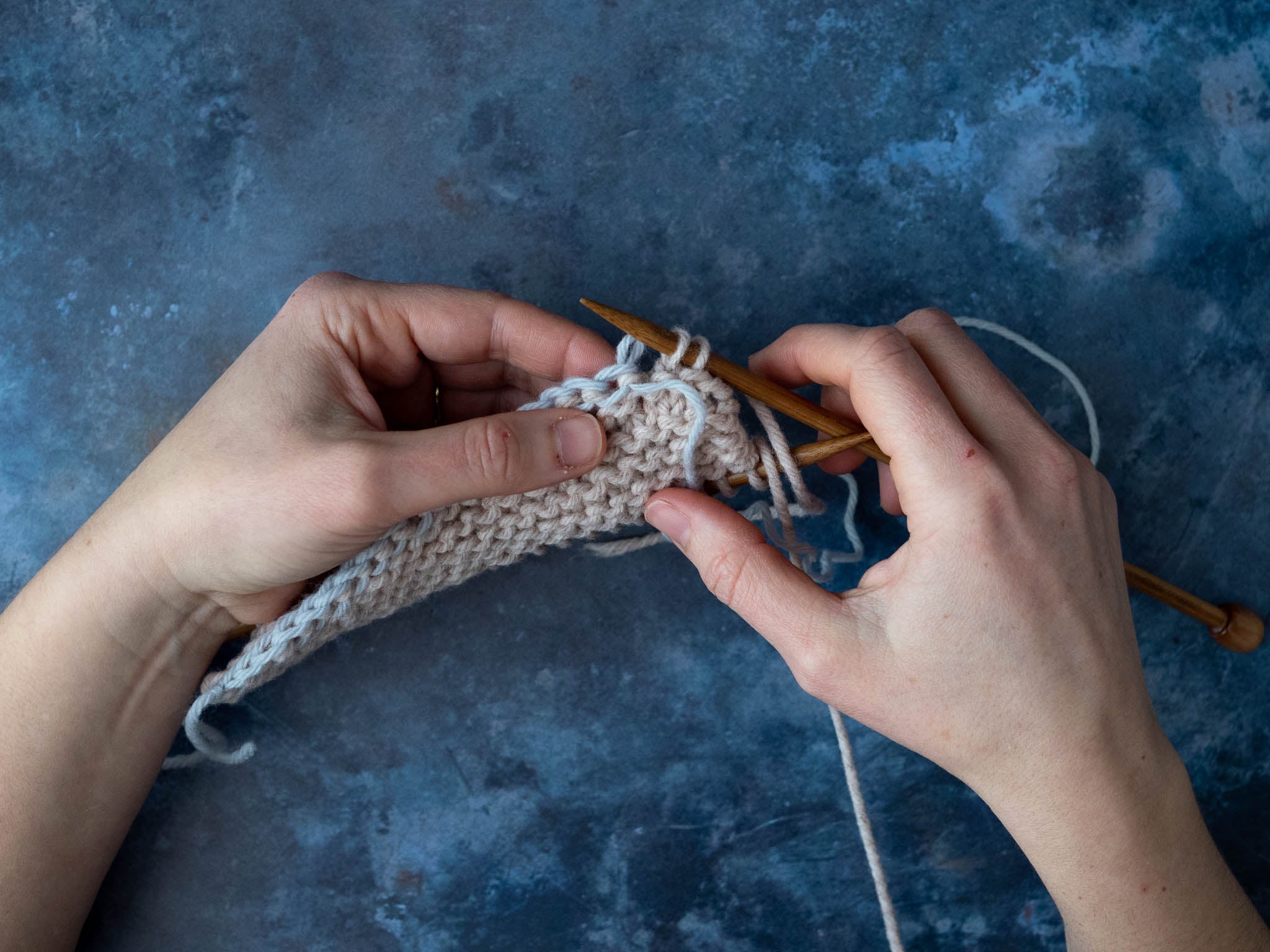 Place each stitch onto the needle as you unzip the chain.