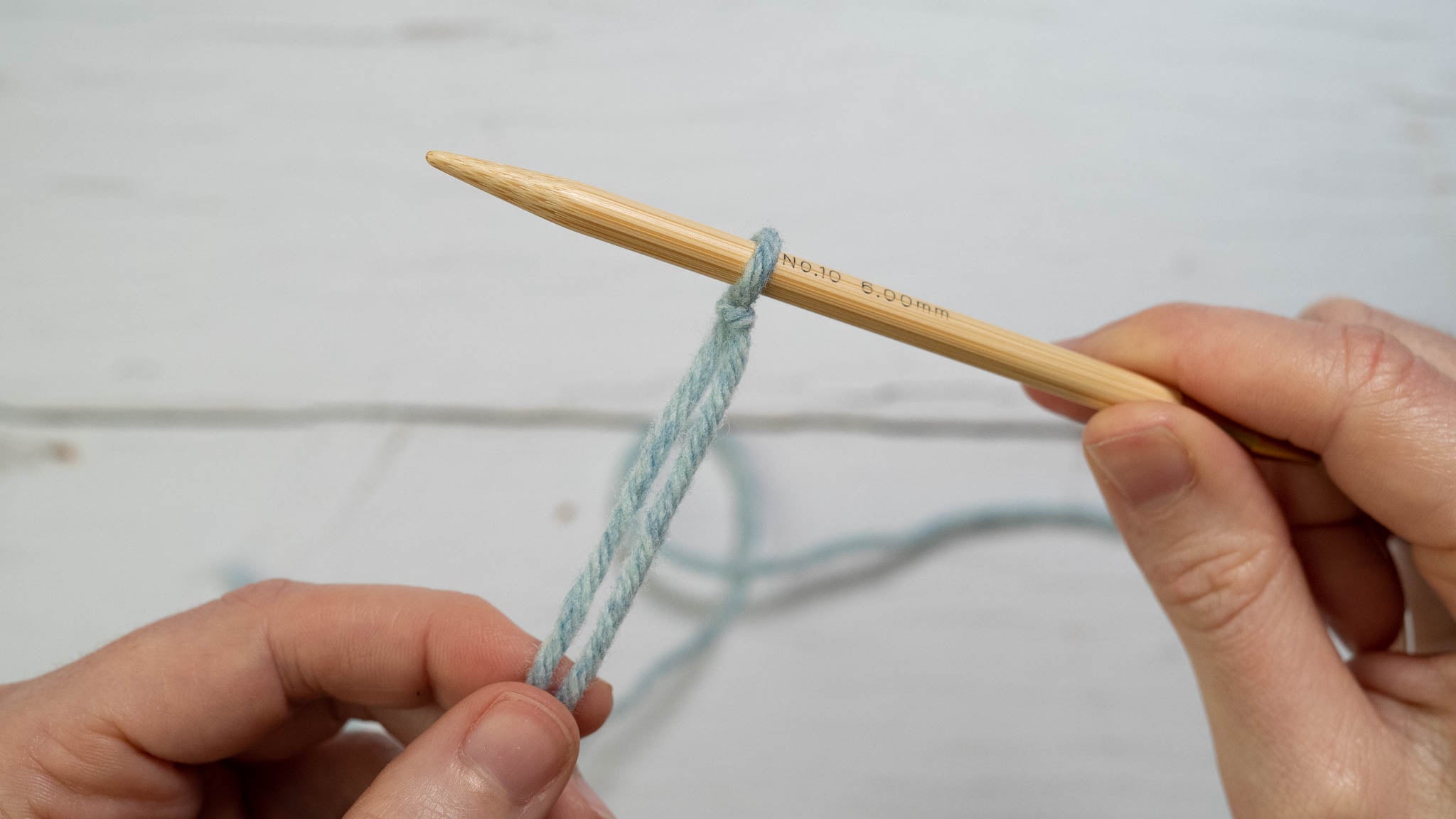 a slipknot on a knitting needle, which is held in the right hand