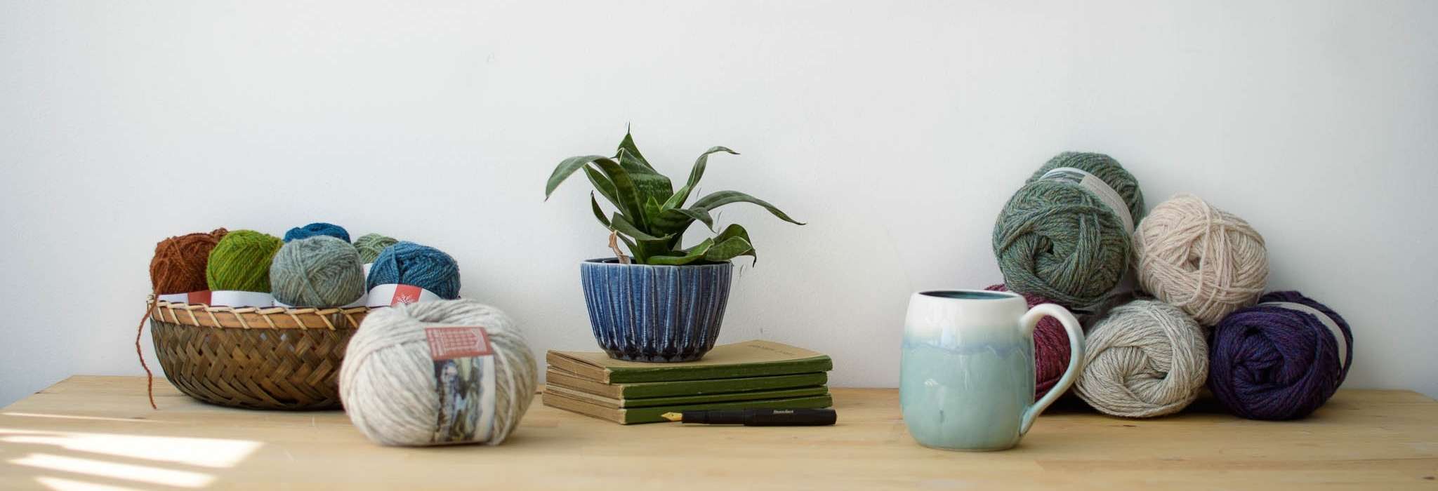 banner image shows a table with yarn, a plant and a mug