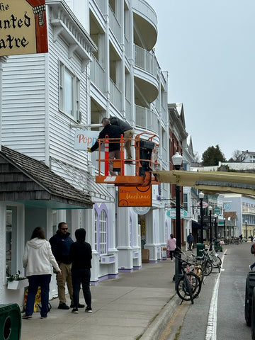 Poppins on Mackinac sign being installed for the 2023 Season