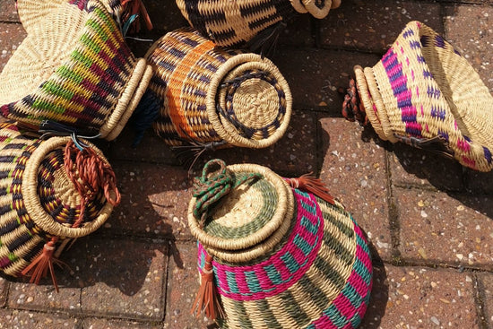 How to Reshape African Baskets: a man checking out a woven basket in a store