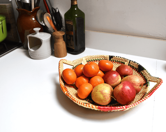 Ways to Tidy Up Your Home Using Woven Baskets: a Rufina Designs fruit basket filled with fruits