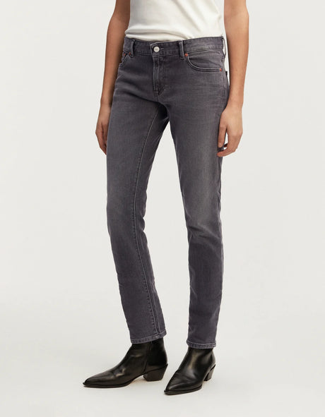 A woman wearing Denham comfort stretch black denim jeans and a white t-shirt.