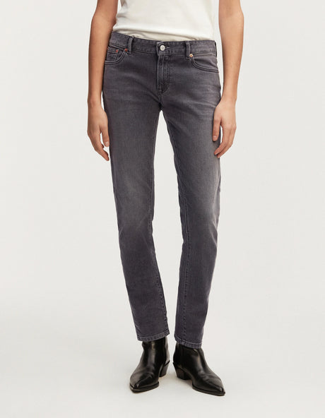 A woman wearing the MONROE - Authentic Grey Wash black denim jeans from Denham's Authentics range and a white t-shirt.