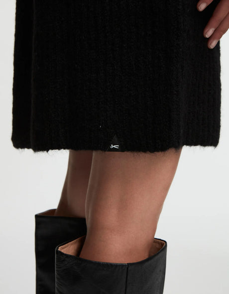 A woman wearing ELLE Dress - Black and a knit sweater dress by Denham.
