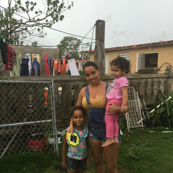 Puerto Rican family with Luci Outdoor 2.0 light