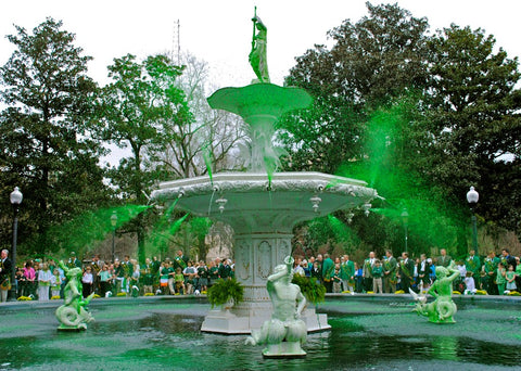 A fountain in Savannah Georgia with child angels floating on the water, shooting green water out of their trumpets.