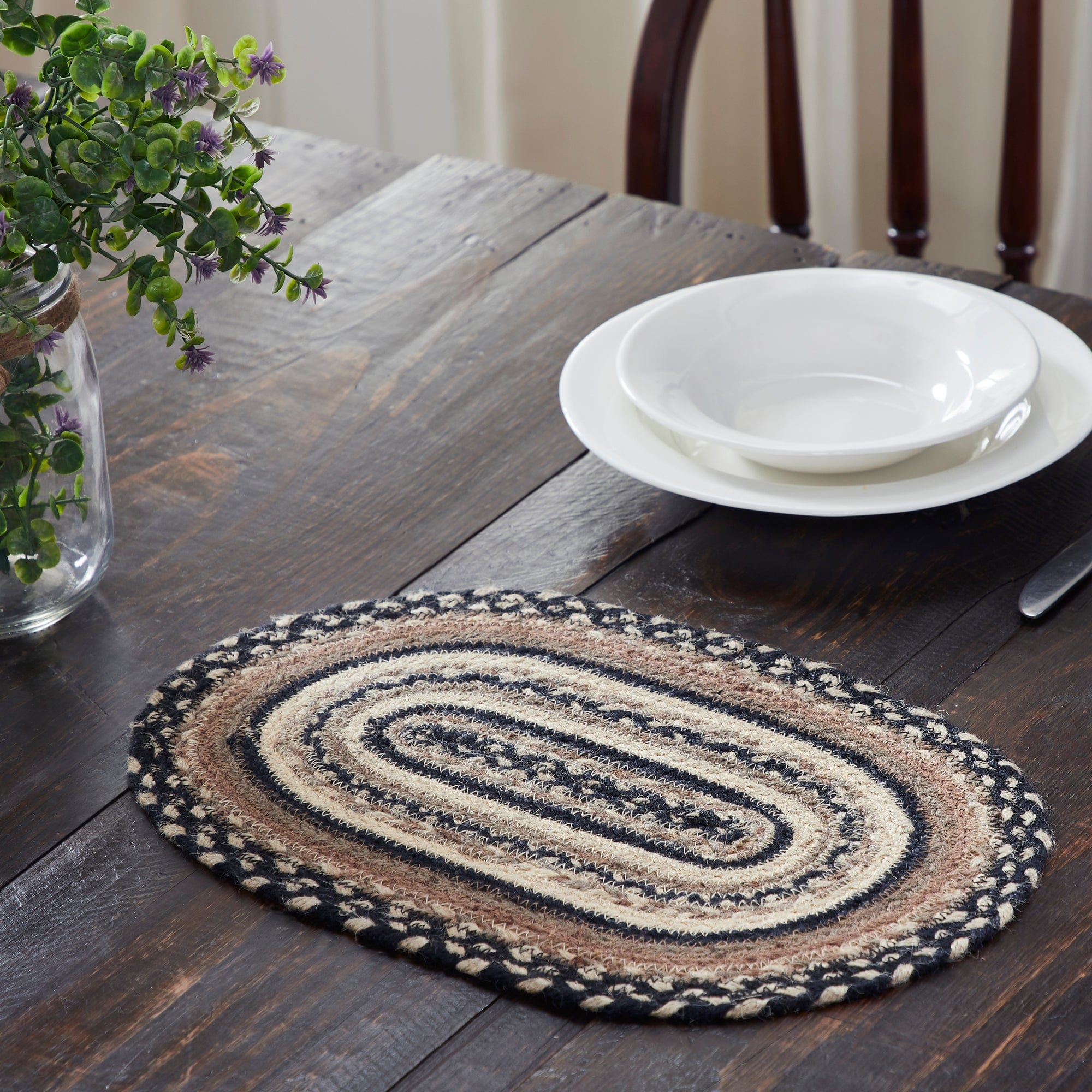 https://cdn.shopify.com/s/files/1/1069/0756/products/april-olive-placemat-sawyer-mill-charcoal-creme-jute-oval-placemat-10x15-31228821373102.jpg?v=1698785999