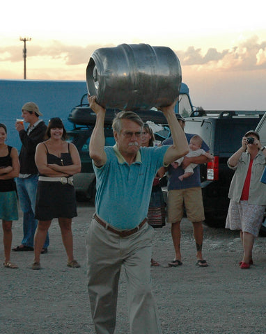 older gent competing in a keg toss
