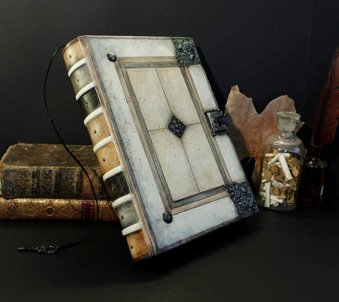Large white journal with metal hardware