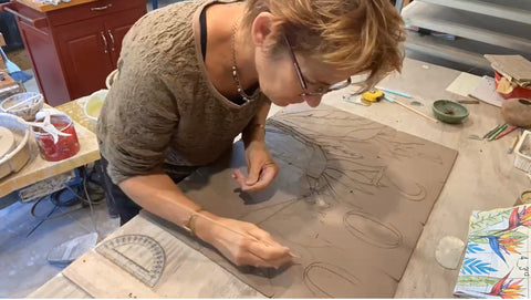 Brenda working on an artful address in her clay studio