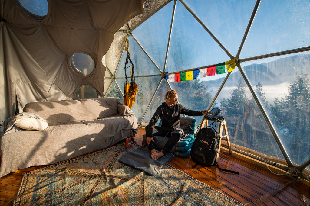 Mark Abma looks out the windows of his geodesic dome at Concept Neverland